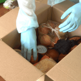 Uma pessoa descarregando uma caixa de alimentos